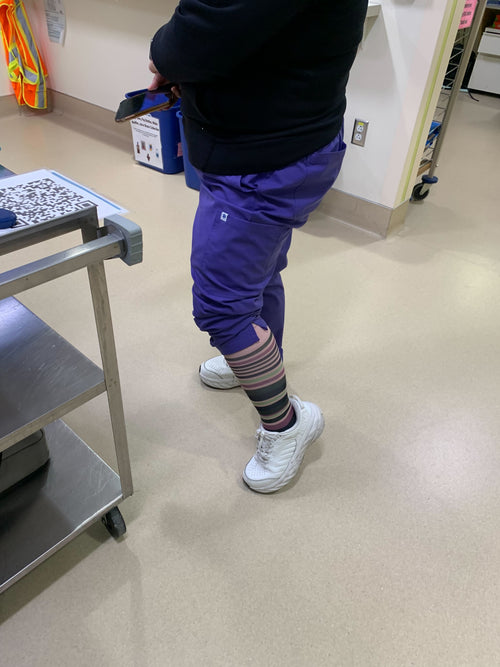 A nurse wearing Dr. Johnny's striped compression socks